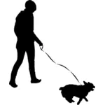 Žena chůze psa silueta