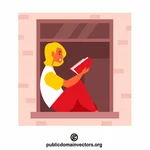 Žena čte knihu na okně